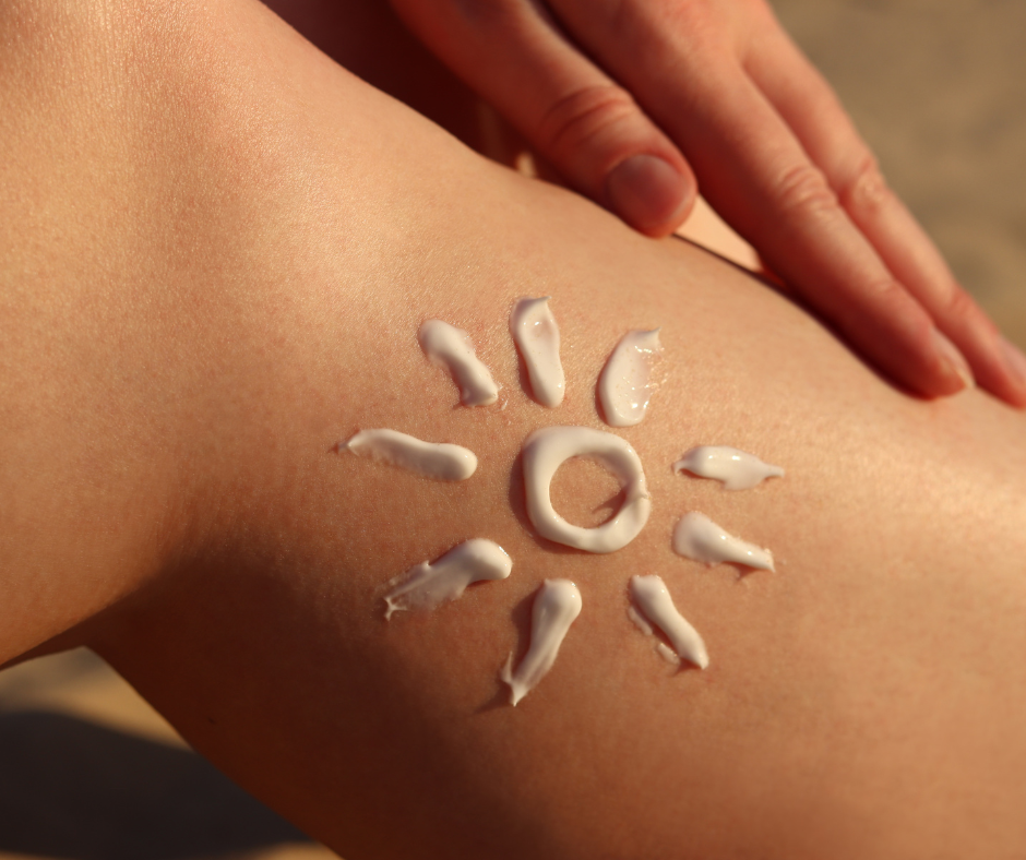 A leg with suncream on it in the shape of a sun.